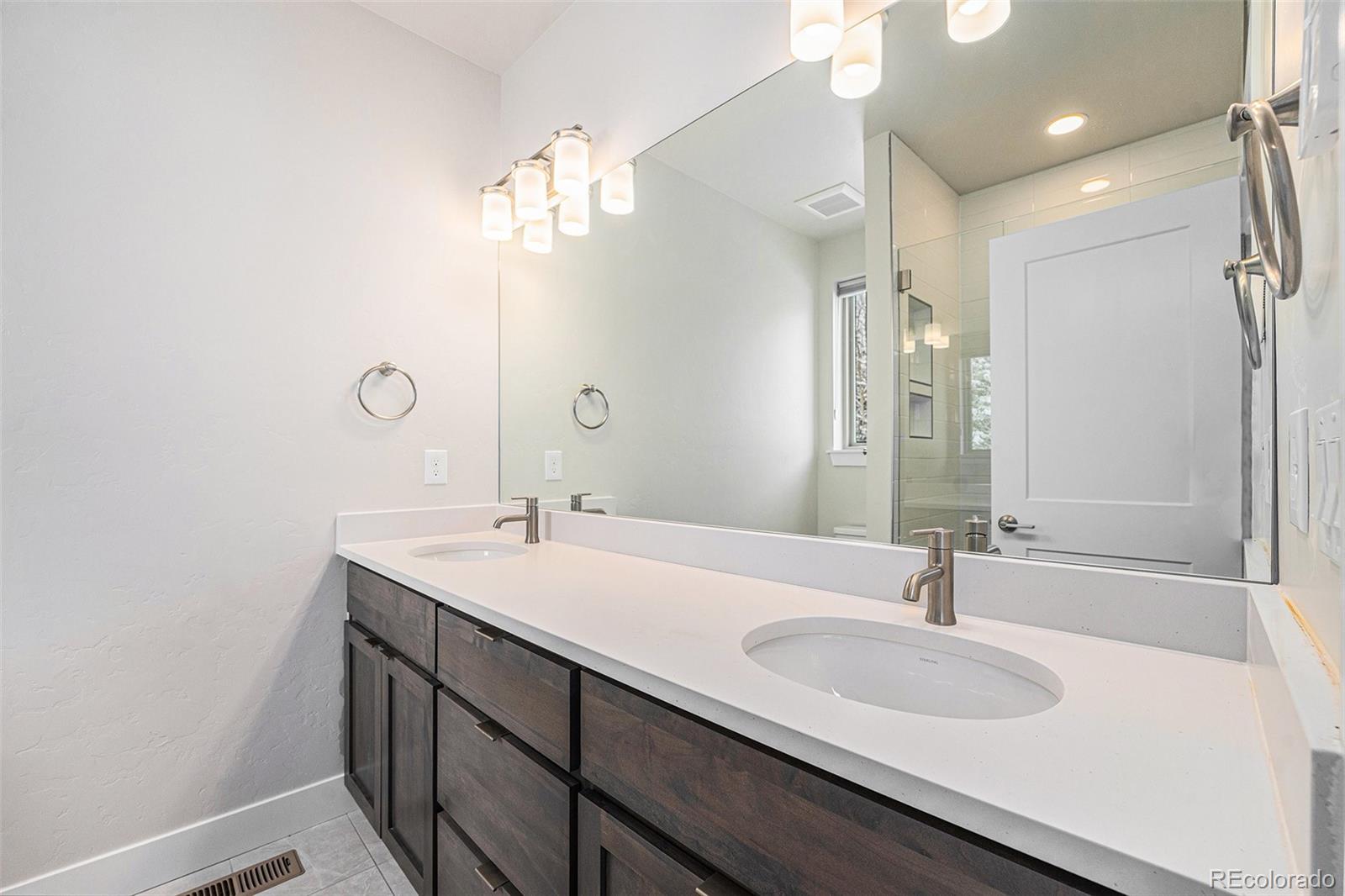 15 Explorers Avenue Fraser, CO 80442 - Photo 13 of 25 a bathroom with a sink double vanity and a mirror