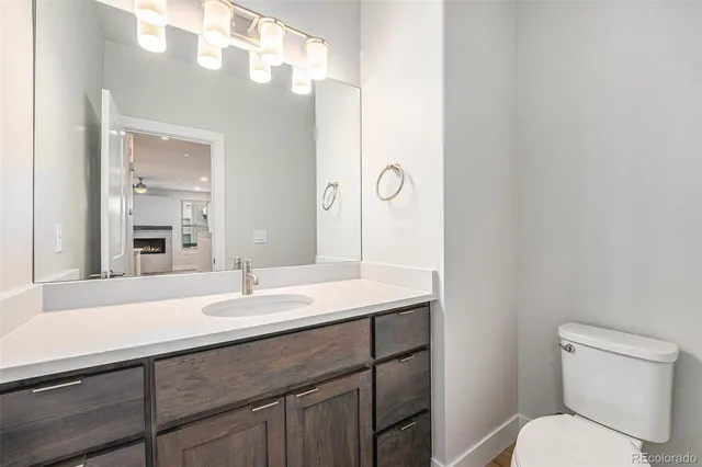 a bathroom with a toilet a sink and mirror