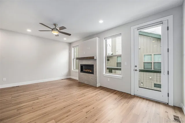wooden floor in an empty room with a fireplace