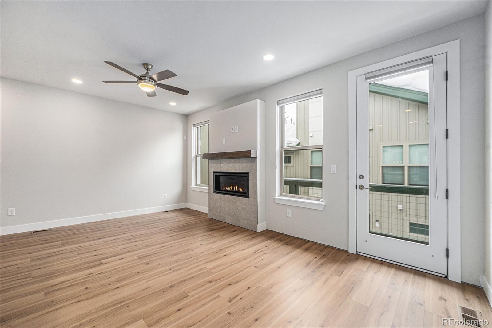 15 Explorers Avenue Fraser, CO 80442 - Photo 4 of 25 wooden floor in an empty room with a fireplace
