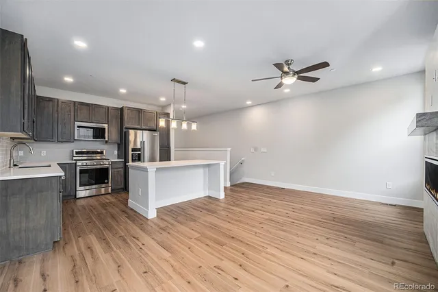 a view of kitchen with sink microwave and refrigerator