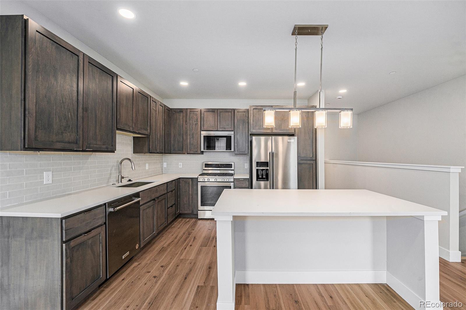 15 Explorers Avenue Fraser, CO 80442 - Photo 8 of 25 a kitchen with stainless steel appliances a sink stove and refrigerator
