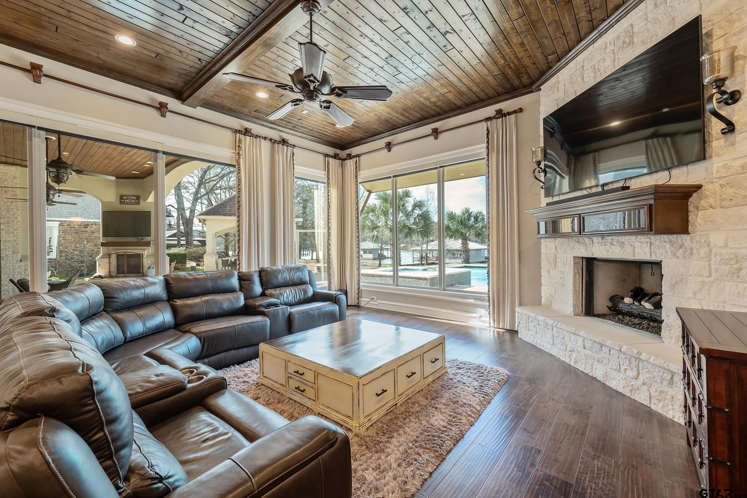 13793 Peninsula Road Whitehouse, TX 75791 - Photo 3 of 48 a living room with furniture a flat screen tv and a fireplace