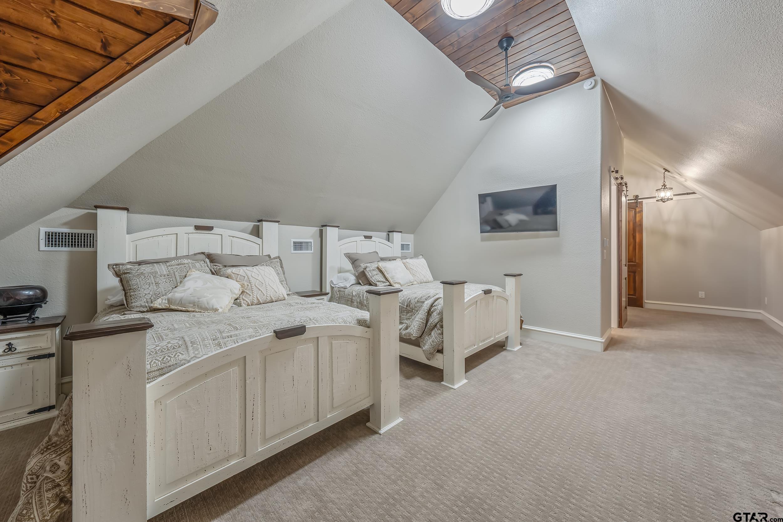 13793 Peninsula Road Whitehouse, TX 75791 - Photo 33 of 48 a spacious bedroom with a bed and a cabinets