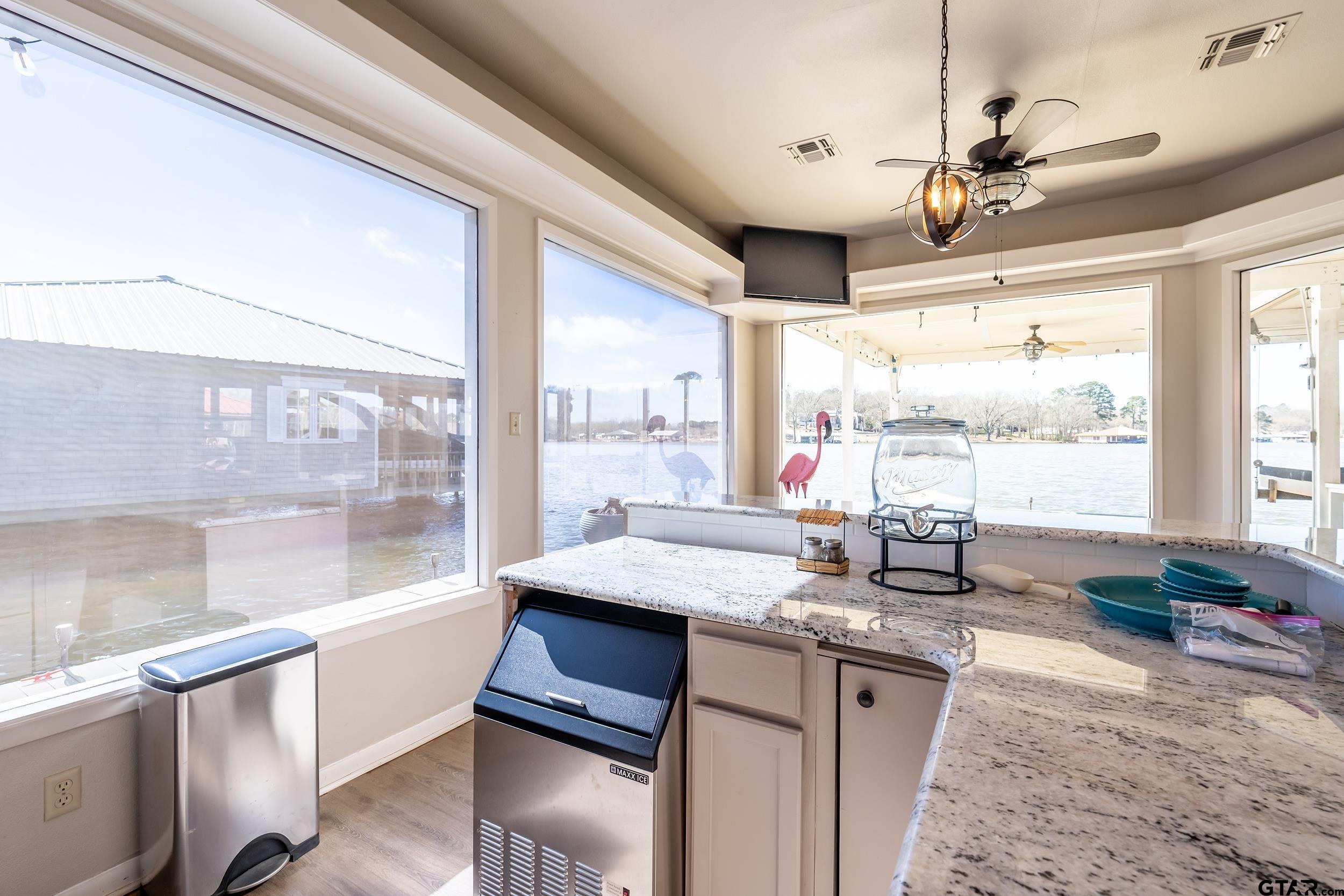 13793 Peninsula Road Whitehouse, TX 75791 - Photo 45 of 48 a kitchen with granite countertop a stove a sink and wooden cabinets