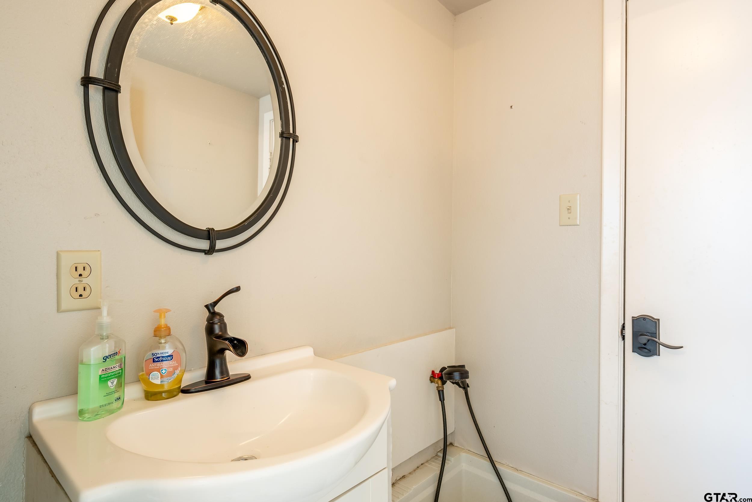 13793 Peninsula Road Whitehouse, TX 75791 - Photo 46 of 48 a bathroom with a sink and a mirror