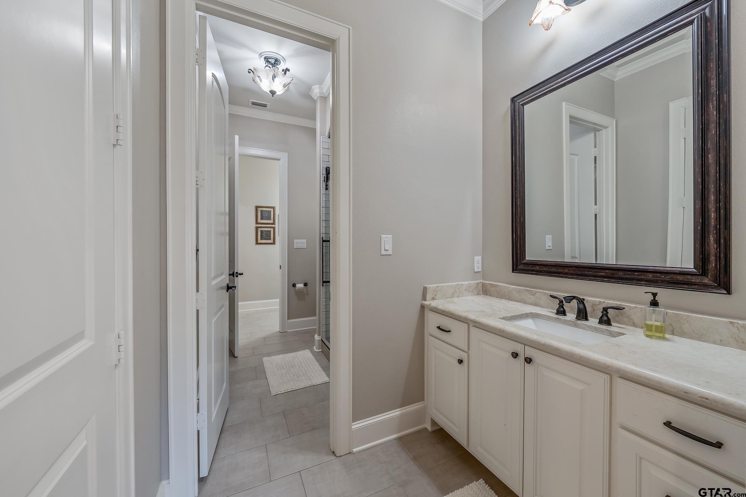 13793 Peninsula Road Whitehouse, TX 75791 - Photo 9 of 48 a bathroom with a double vanity sink and mirror with shower