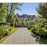a view of a house with a yard and garden