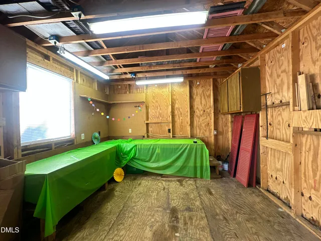 a backyard of a house with a garden and outdoor seating