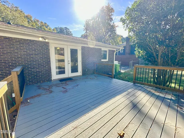 a view of a house with wooden deck