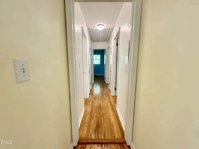 a view of a hallway with wooden floor