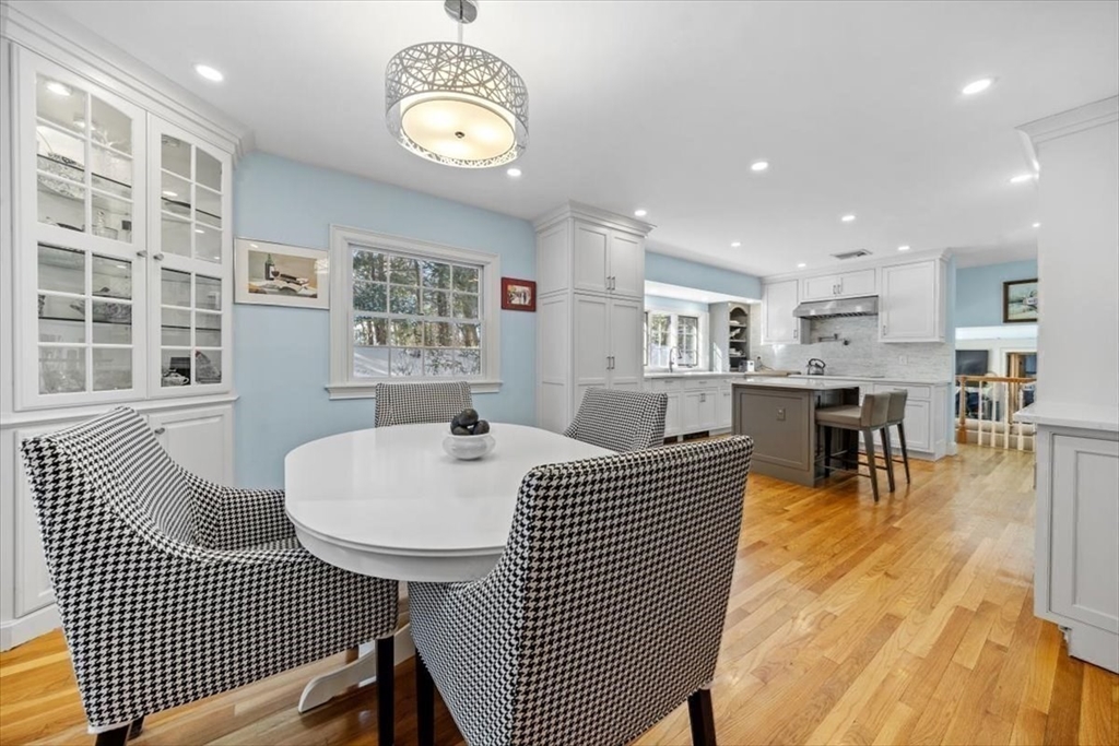 5 Old County Road Hingham, MA 02043 - Photo 12 of 42 a living room with couches a dining table and kitchen view with wooden floor