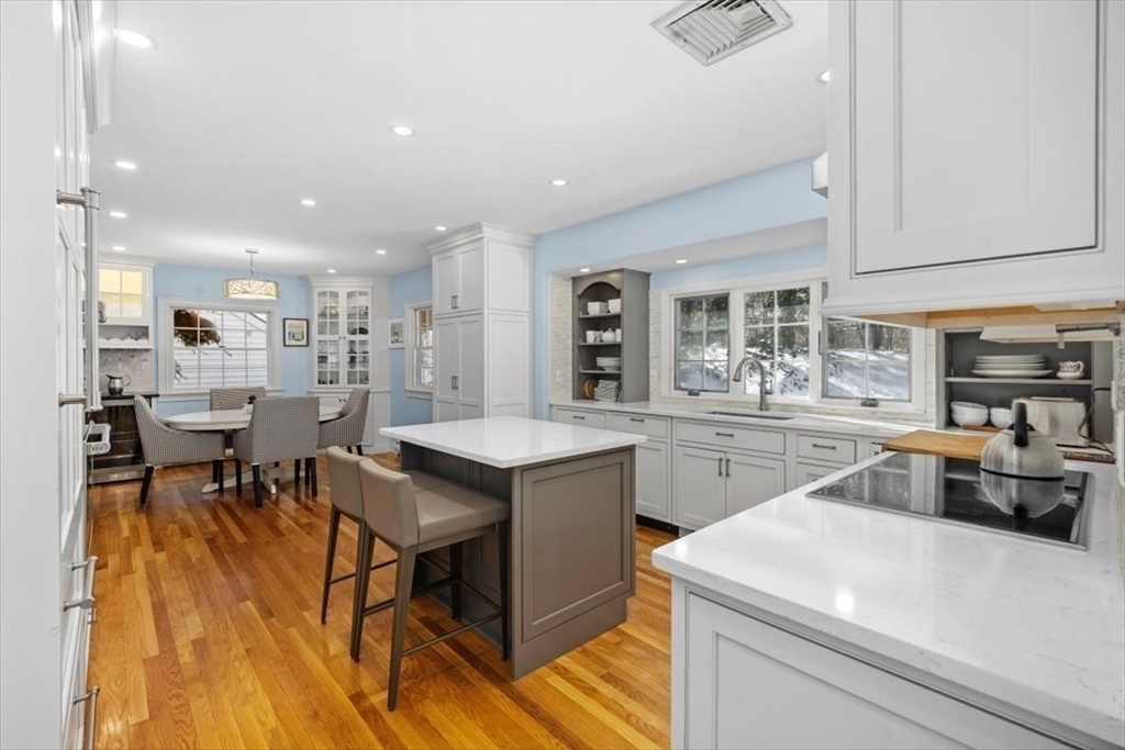5 Old County Road Hingham, MA 02043 - Photo 14 of 42 a kitchen with a stove a sink a dining table and chairs