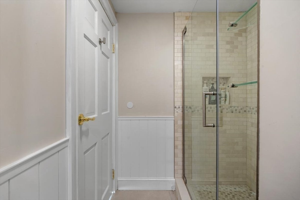 5 Old County Road Hingham, MA 02043 - Photo 21 of 42 a bathroom with a glass shower door