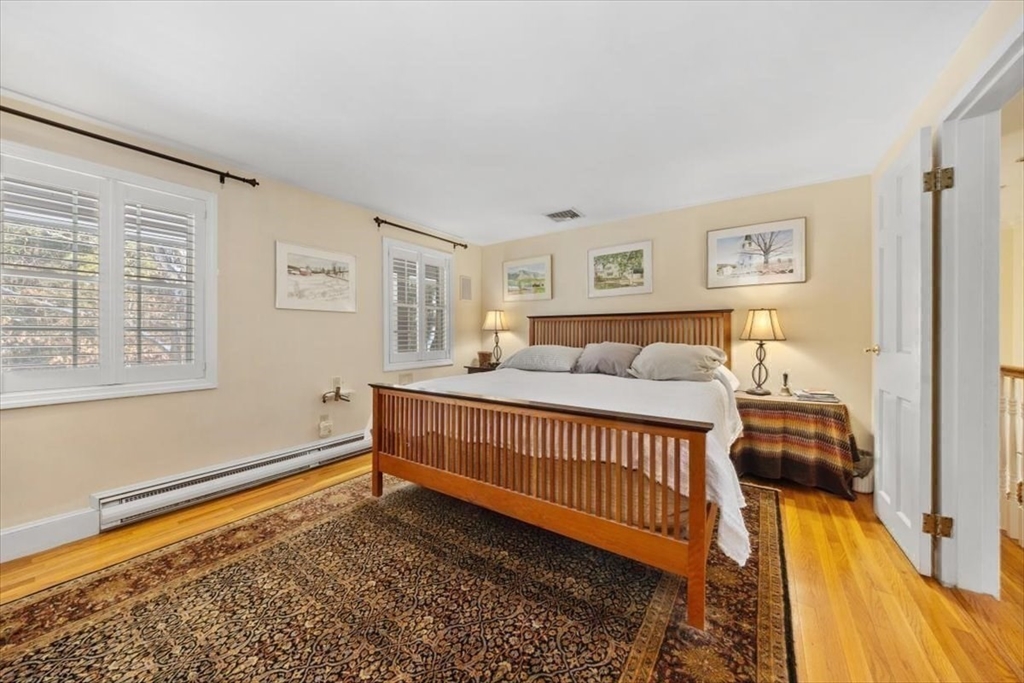 5 Old County Road Hingham, MA 02043 - Photo 24 of 42 a bedroom with a bed and wooden floor