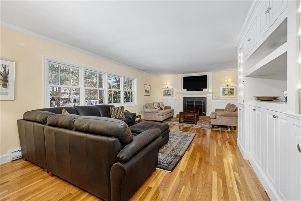 5 Old County Road Hingham, MA 02043 - Photo 9 of 42 a living room with furniture a flat screen tv and a fireplace
