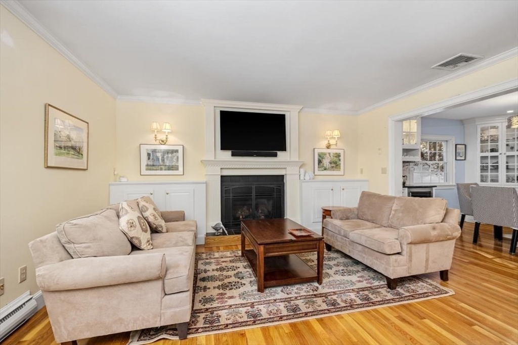 5 Old County Road Hingham, MA 02043 - Photo 10 of 42 a living room with furniture a flat screen tv and a fireplace