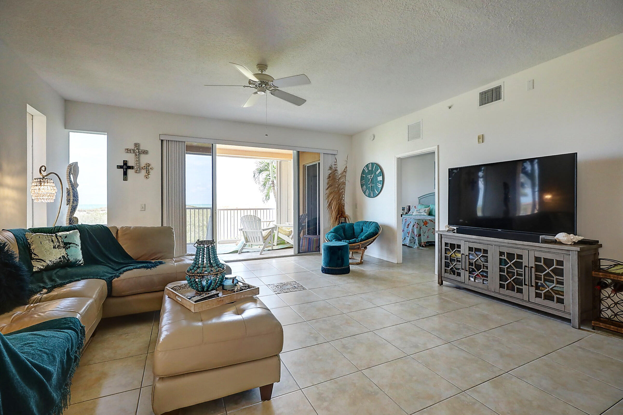 1002 Windward Drive Fort Pierce, FL 34949 - Photo 14 of 122 a living room with furniture and a flat screen tv