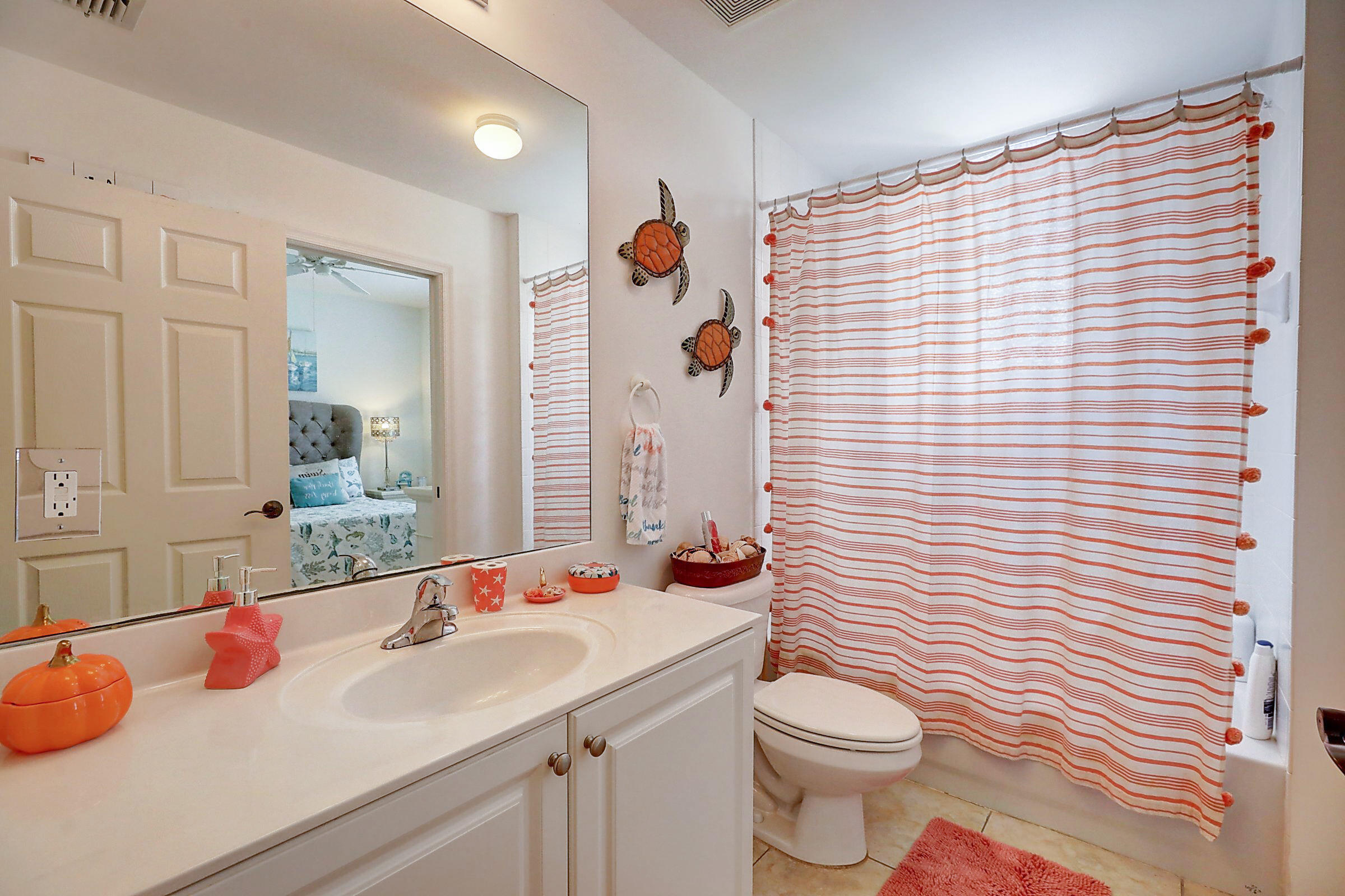 1002 Windward Drive Fort Pierce, FL 34949 - Photo 20 of 122 a bathroom with a sink a toilet and shower curtain