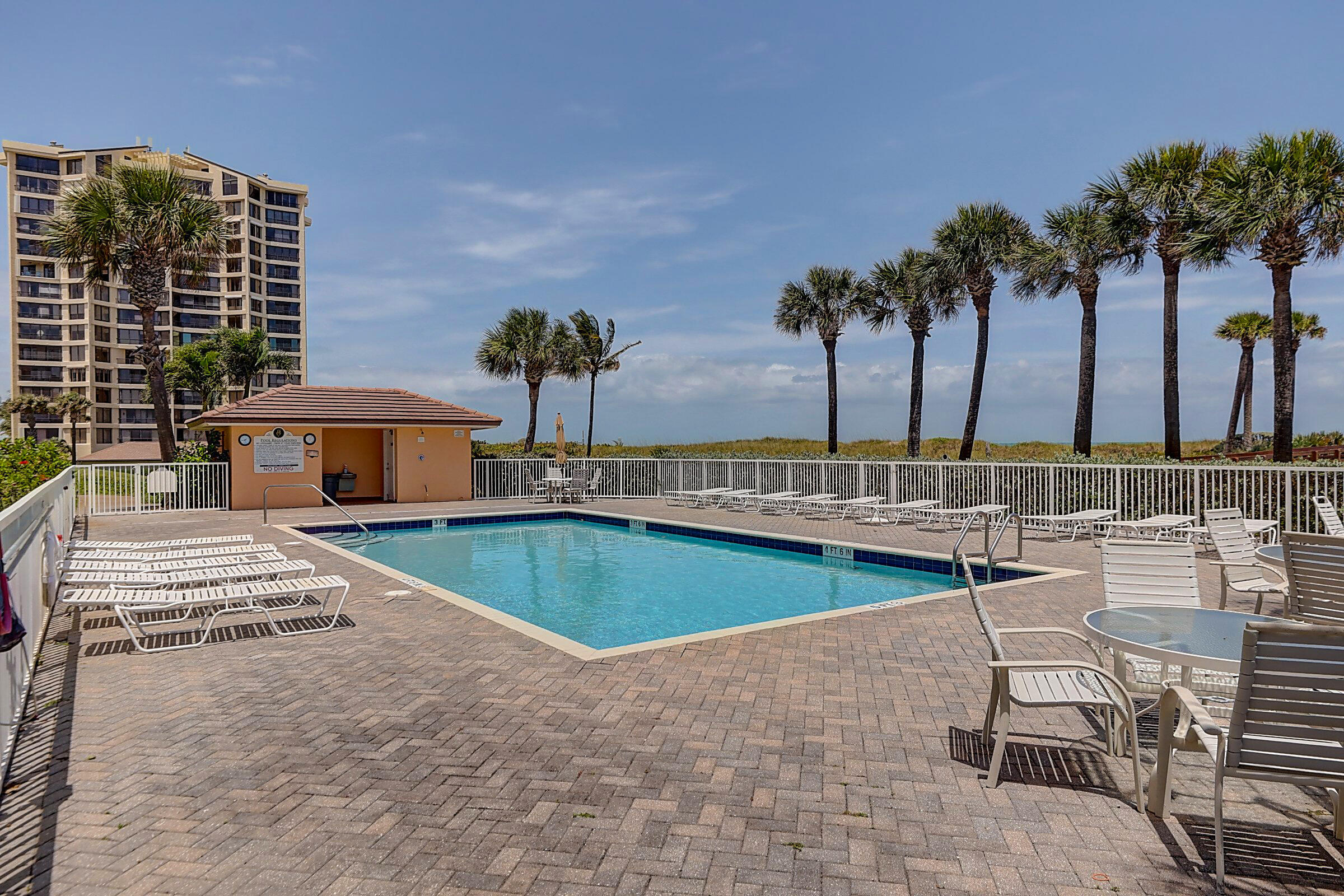 1002 Windward Drive Fort Pierce, FL 34949 - Photo 22 of 122 a view of a swimming pool with chairs