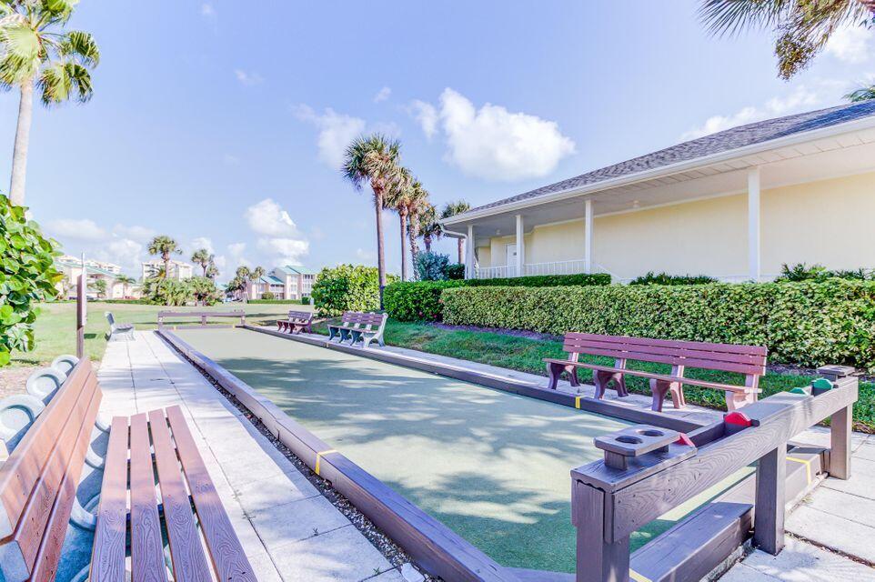1002 Windward Drive Fort Pierce, FL 34949 - Photo 32 of 122 a view of a patio with couches table and chairs with potted plants