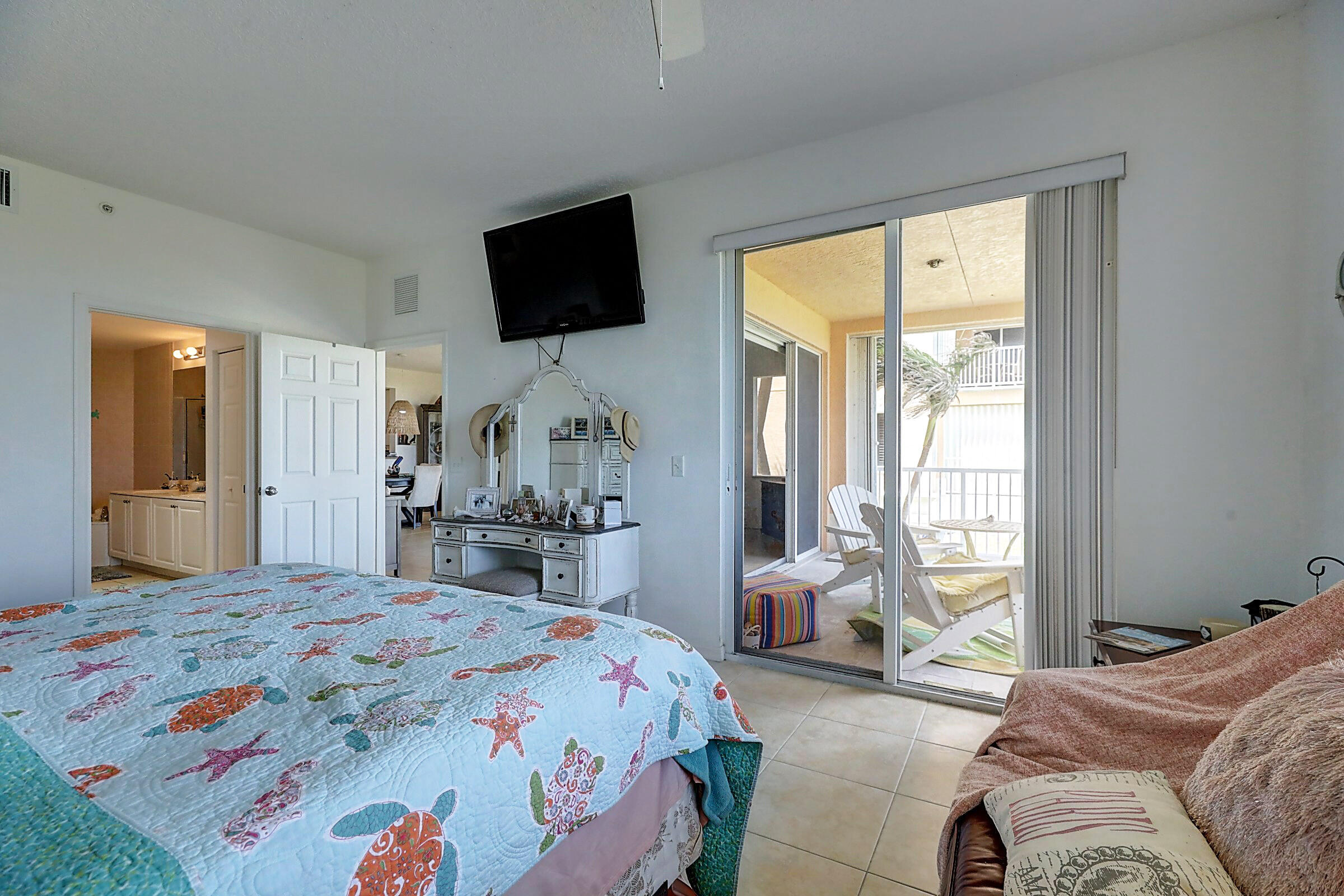 1002 Windward Drive Fort Pierce, FL 34949 - Photo 82 of 122 a bedroom with a bed wooden floor and a large window