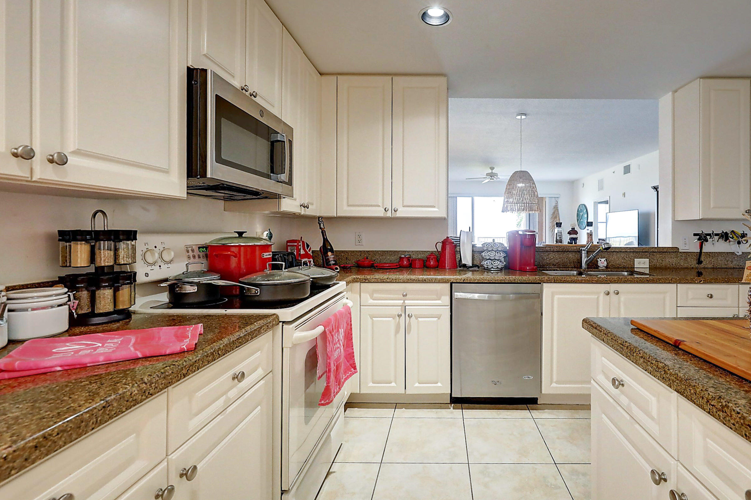 1002 Windward Drive Fort Pierce, FL 34949 - Photo 89 of 122 a kitchen with stainless steel appliances granite countertop a sink dishwasher stove top oven and cabinets with wooden floor