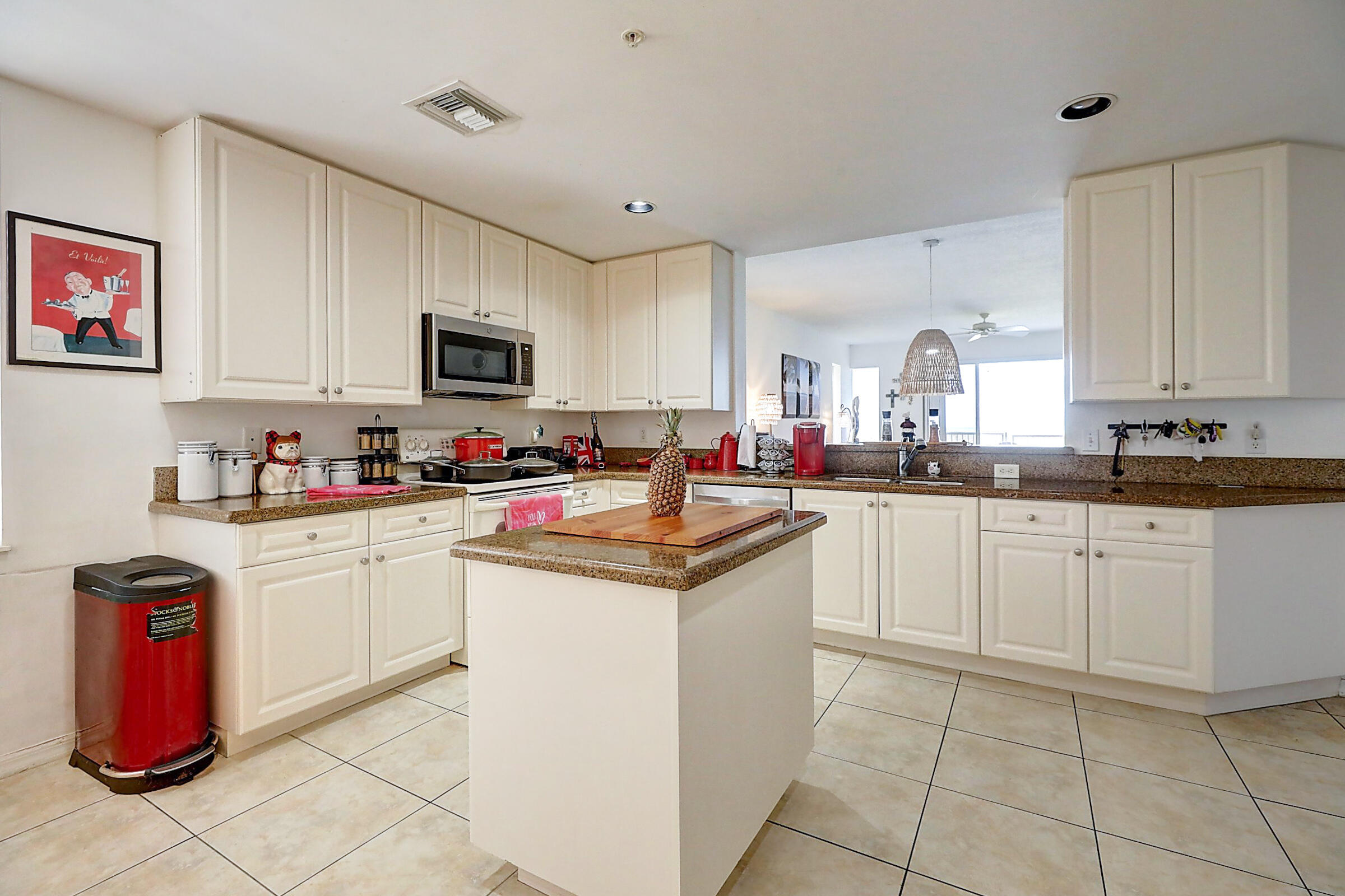 1002 Windward Drive Fort Pierce, FL 34949 - Photo 90 of 122 a kitchen with granite countertop a sink and cabinets