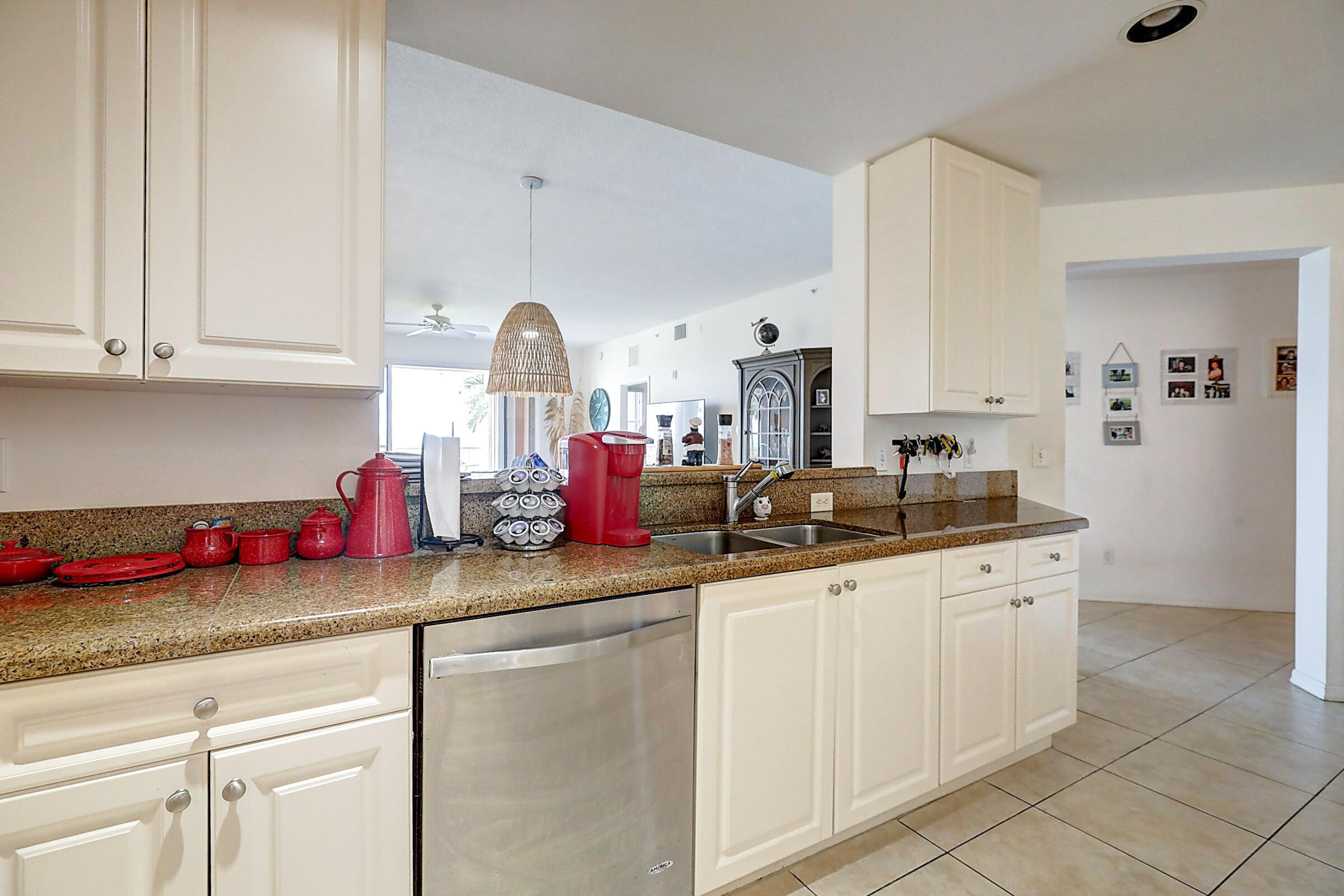 1002 Windward Drive Fort Pierce, FL 34949 - Photo 93 of 122 a kitchen with granite countertop a sink stainless steel appliances and cabinets