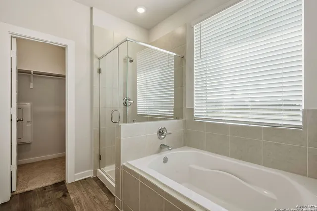 a bathroom with a bathtub and a shower