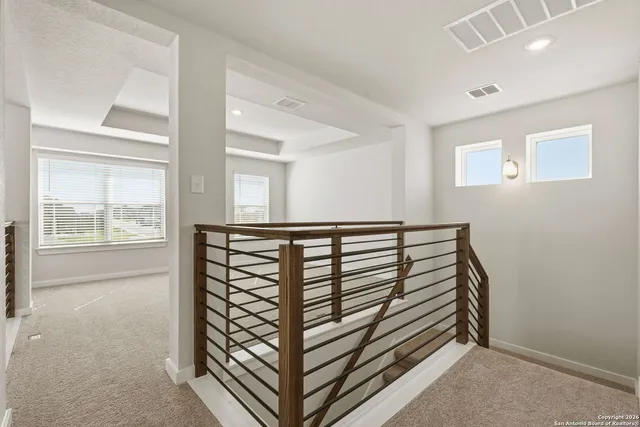 a view of a hallway with windows