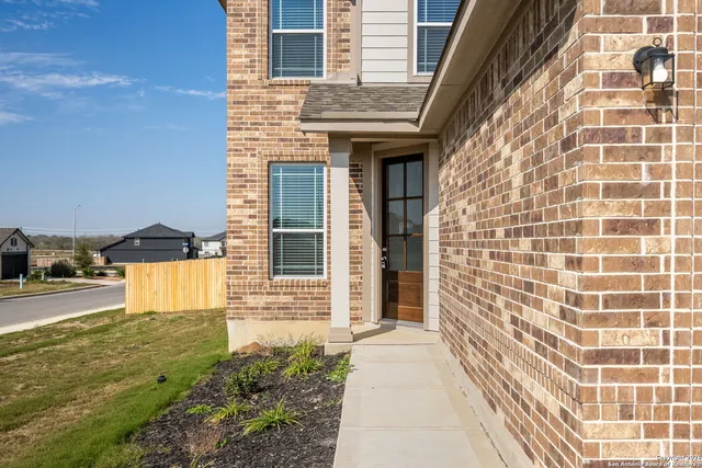 a view of a brick house with a yard