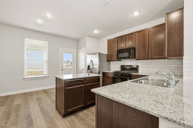 a kitchen with a sink stove and microwave