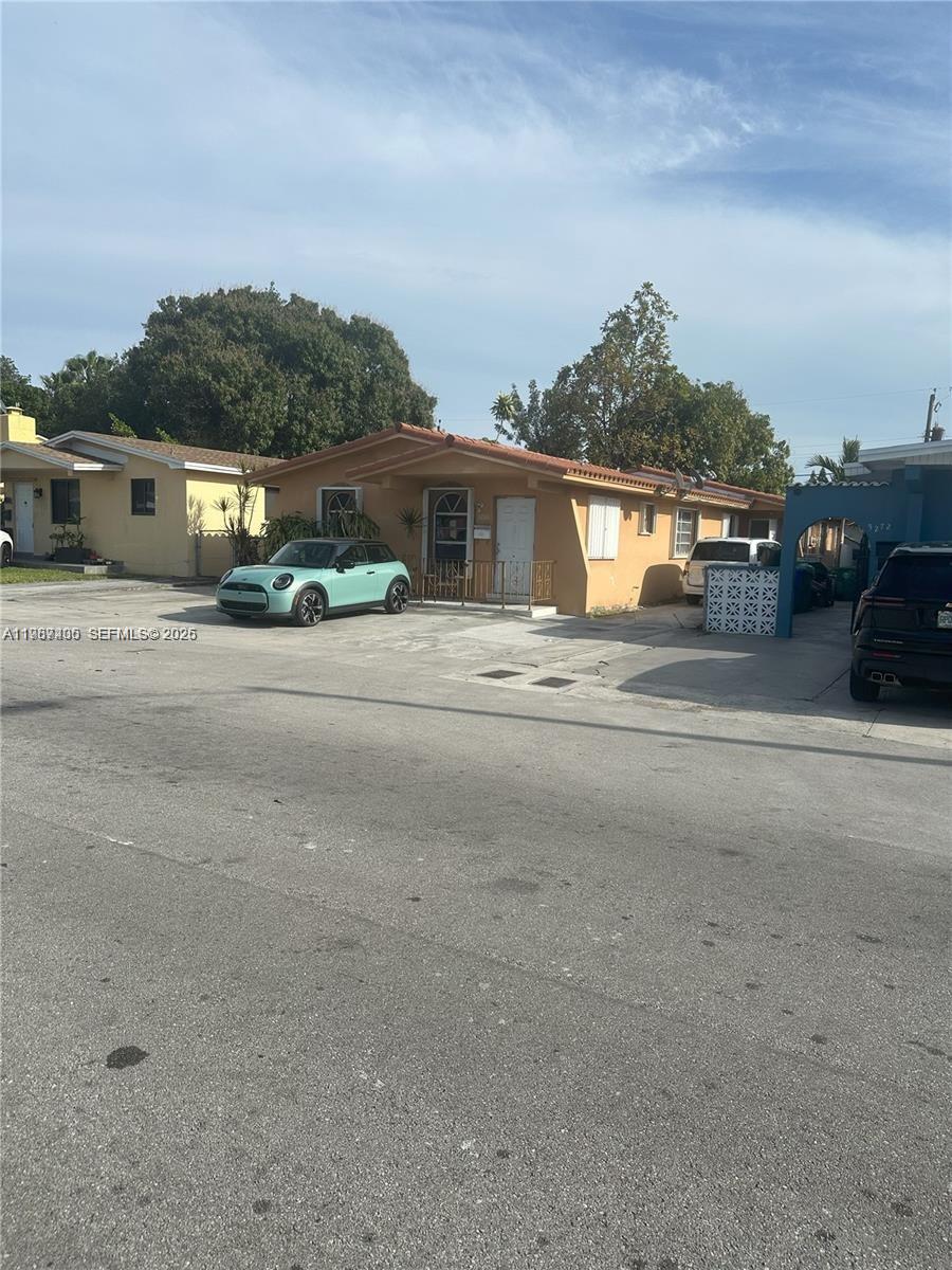 3268 Southwest 25th Street, Unit 3268 Miami, FL 33133 - Photo 2 of 17 a front view of residential houses with yard