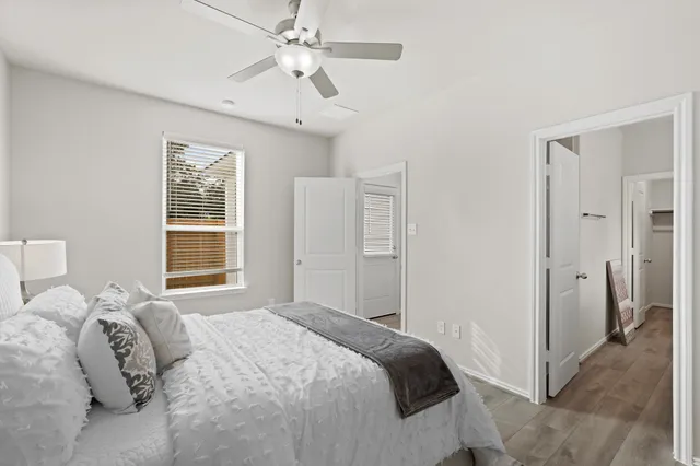 a bedroom with a large bed and a window
