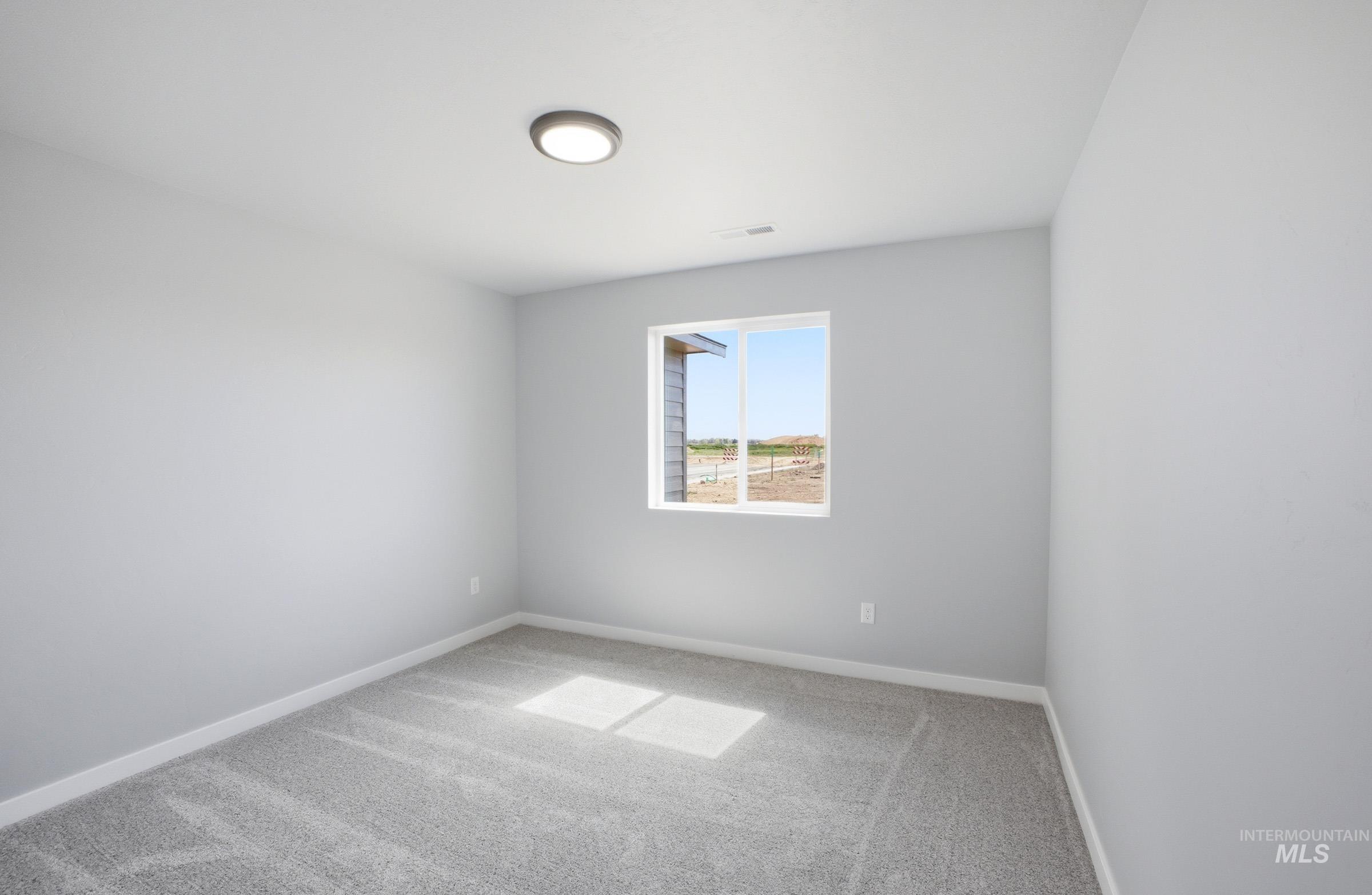 14106 Winding Street Caldwell, ID 83607 - Photo 10 of 18 Bright room with light gray carpet flooring, white baseboards, and a single window