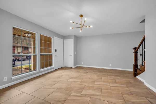 a kitchen with granite countertop a refrigerator stove top oven and sink