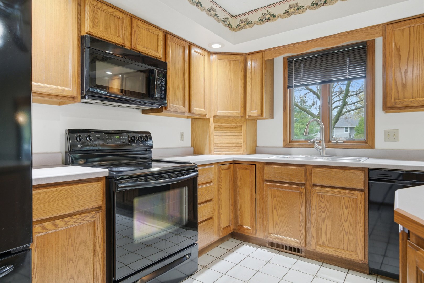 1016 North 7th Street Rochelle, IL 61068 - Photo 9 of 39 a kitchen with a stove a sink and a microwave