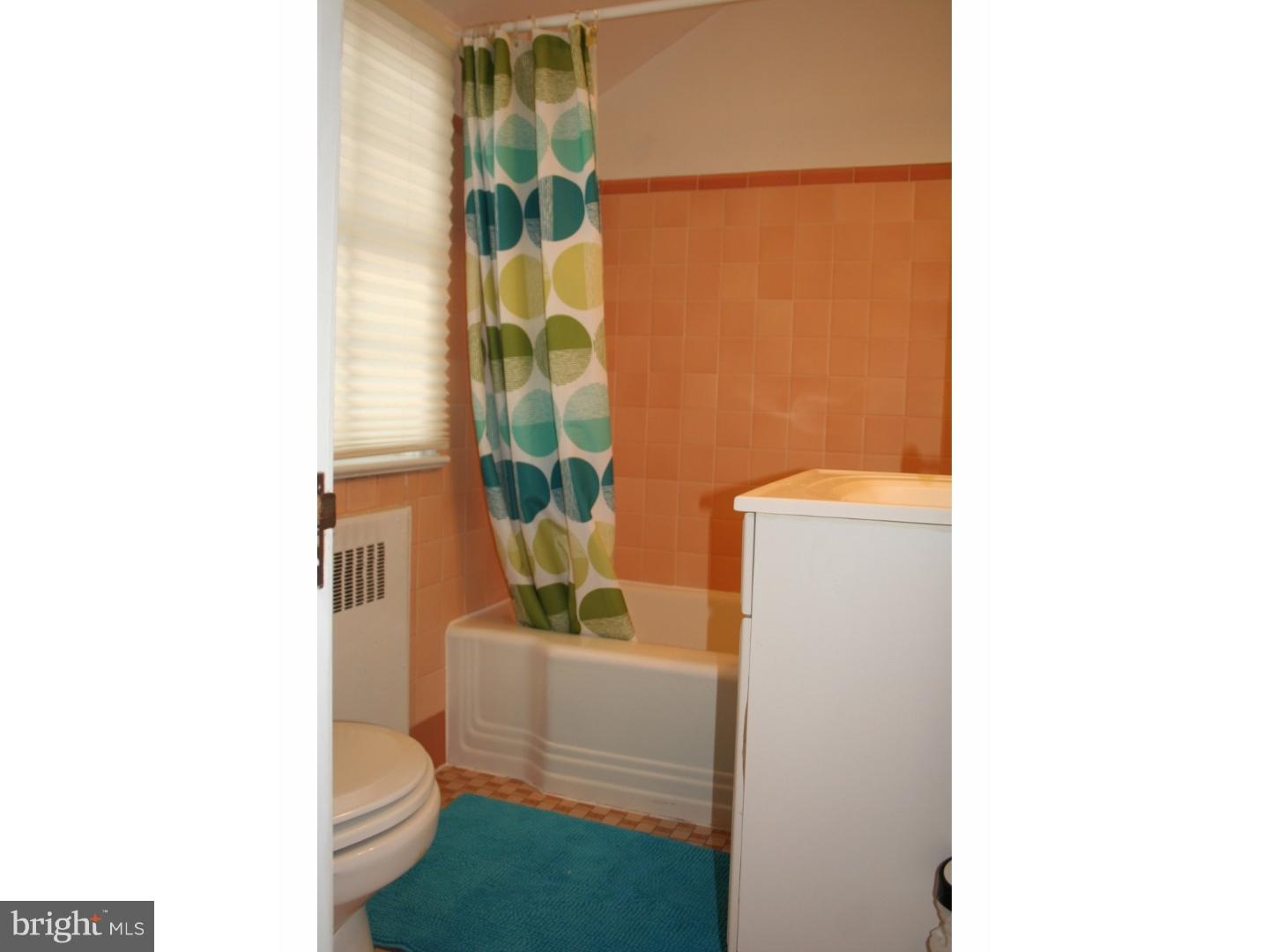 144 Henley Road Wynnewood, PA 19096 - Photo 18 of 21 a bathroom with a toilet and a shower curtain