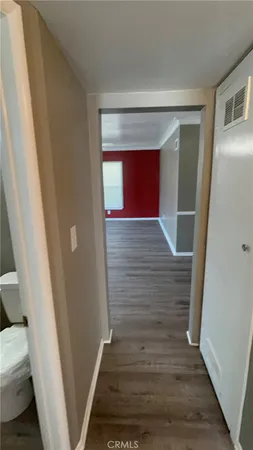 a view of hallway with wooden floor