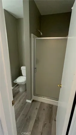 a bathroom with a toilet and a shower