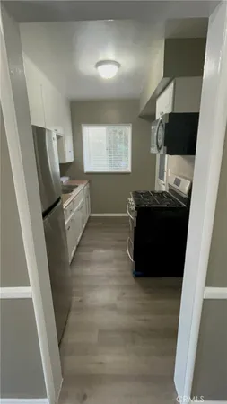 a living room with wooden floor and furniture