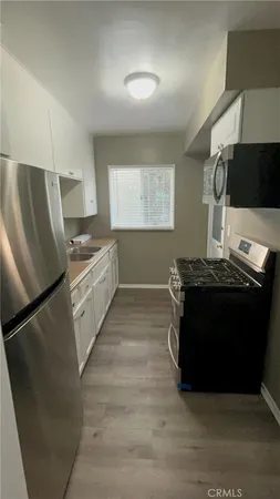 a kitchen with stainless steel appliances a refrigerator and a stove