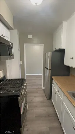 a kitchen with a refrigerator and a stove
