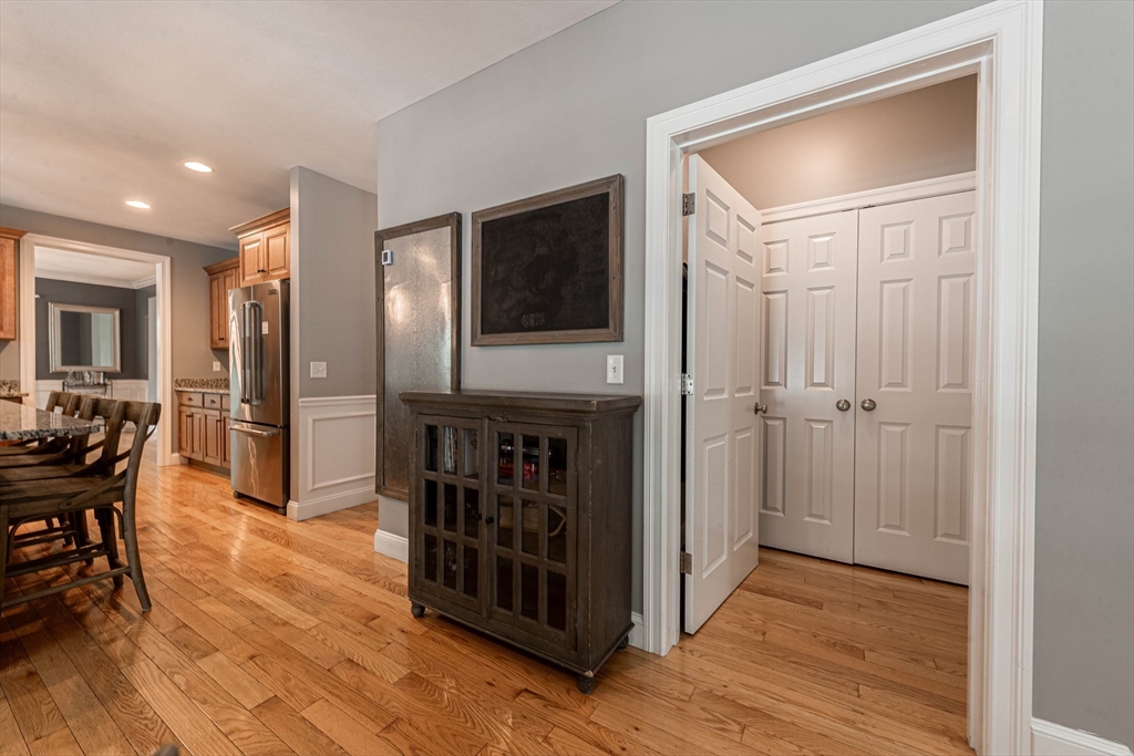22 Jacob Road Windham, NH 03087 - Photo 13 of 42 a view of a hallway with dining room and wooden floor