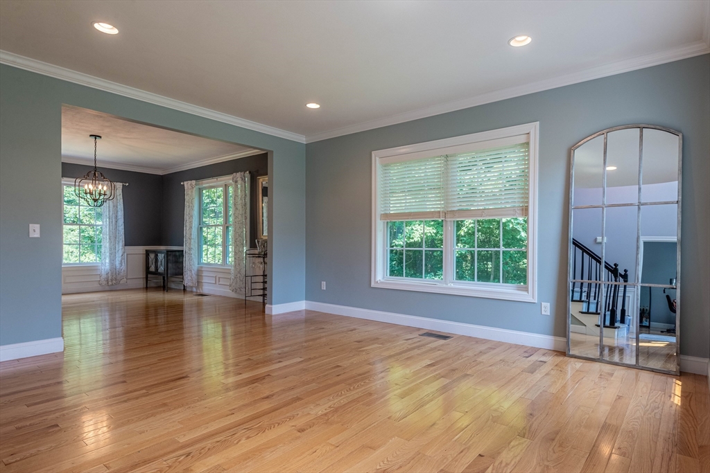 22 Jacob Road Windham, NH 03087 - Photo 17 of 42 an empty room with wooden floor and a fireplace