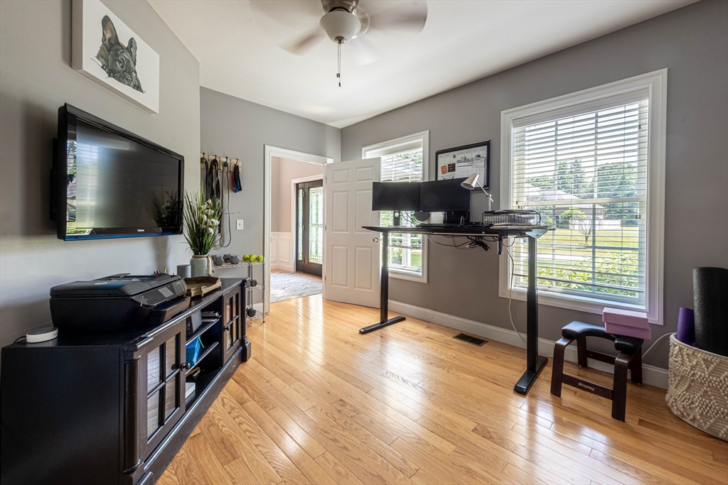22 Jacob Road Windham, NH 03087 - Photo 18 of 42 a kitchen with stainless steel appliances granite countertop a stove top oven a sink dishwasher a dining table and chairs with wooden floor