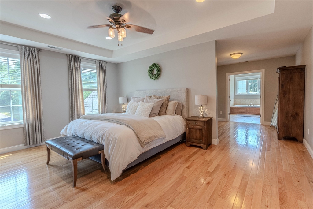 22 Jacob Road Windham, NH 03087 - Photo 19 of 42 a bedroom with a bed and a chandelier