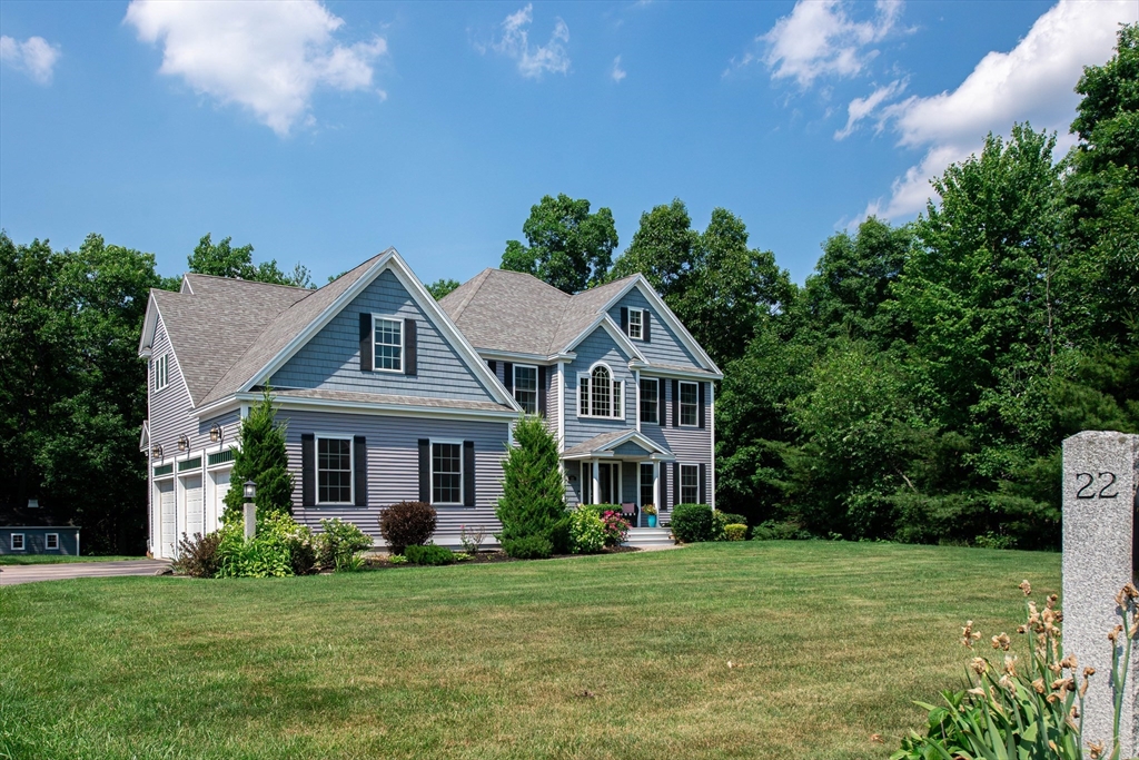 22 Jacob Road Windham, NH 03087 - Photo 2 of 42 a front view of a house with a garden