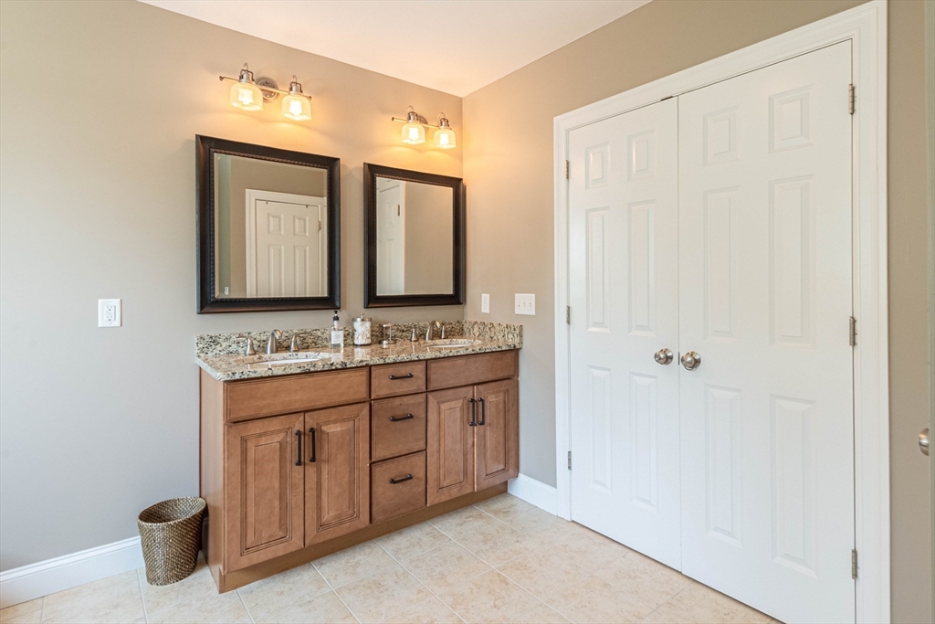 22 Jacob Road Windham, NH 03087 - Photo 21 of 42 a bathroom with a granite countertop sink and a mirror